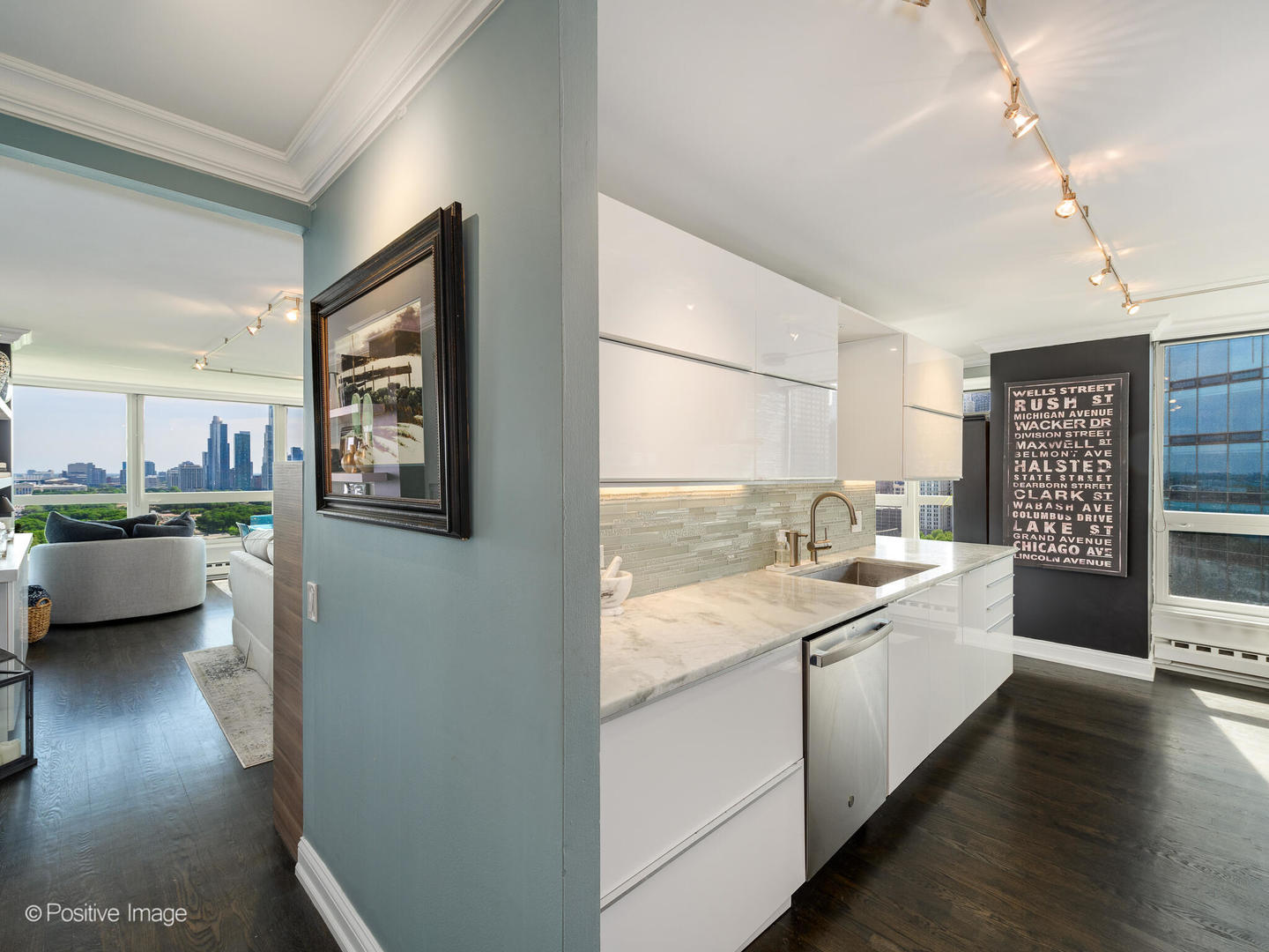 360 East Randolph Street, Unit 2204 Chicago, IL 60601 - Photo 12 of 28 a large white kitchen with a lot of counter space and a wooden floor