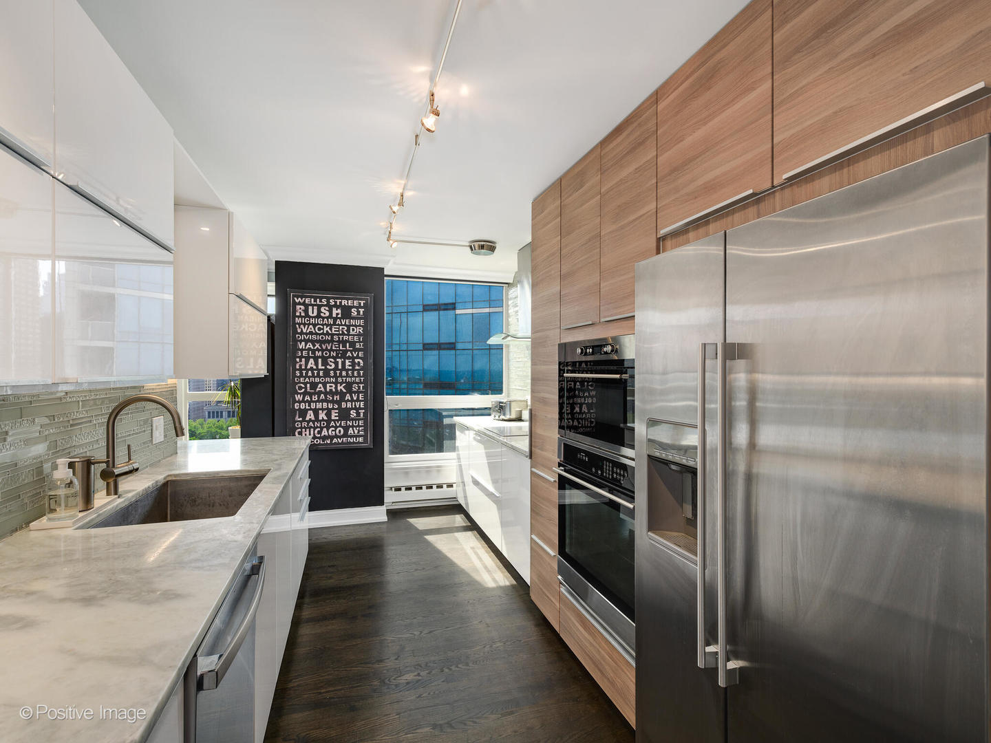 360 East Randolph Street, Unit 2204 Chicago, IL 60601 - Photo 13 of 28 a modern kitchen with stainless steel appliances kitchen island granite countertop a refrigerator and a sink