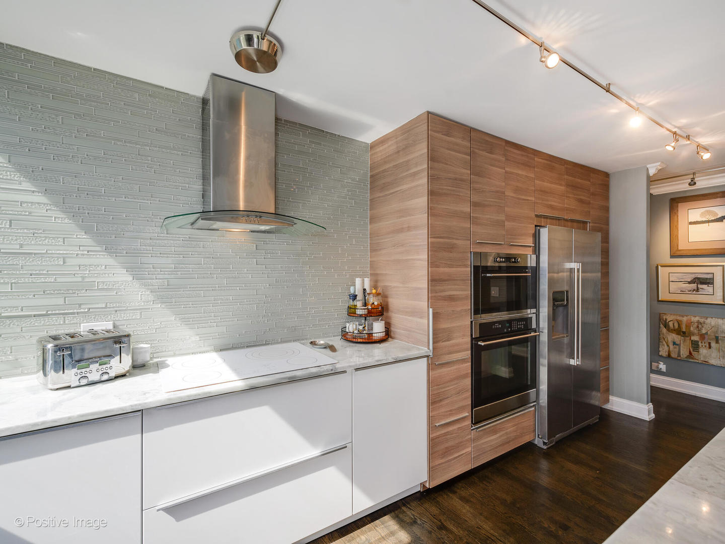 360 East Randolph Street, Unit 2204 Chicago, IL 60601 - Photo 14 of 28 a kitchen with stainless steel appliances kitchen island wooden cabinets and a refrigerator