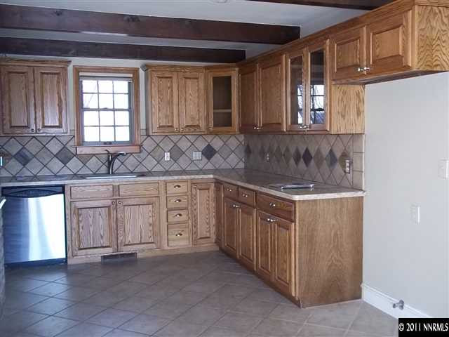 1000 Lampe Road Reno, NV 89511 - Photo 3 of 13 a kitchen with granite countertop a sink and cabinets