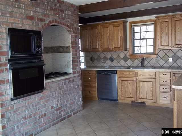 1000 Lampe Road Reno, NV 89511 - Photo 4 of 13 a kitchen with a stove and a microwave