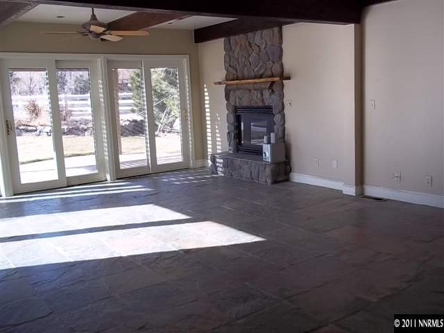 1000 Lampe Road Reno, NV 89511 - Photo 6 of 13 an empty room with fireplace and windows