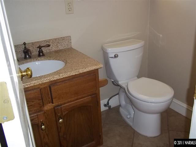 1000 Lampe Road Reno, NV 89511 - Photo 7 of 13 a white toilet sitting next to a bathroom sink