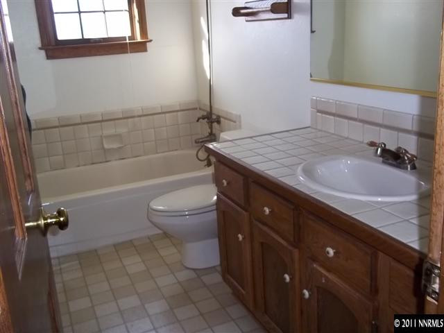 1000 Lampe Road Reno, NV 89511 - Photo 8 of 13 a bathroom with a granite countertop sink toilet and shower