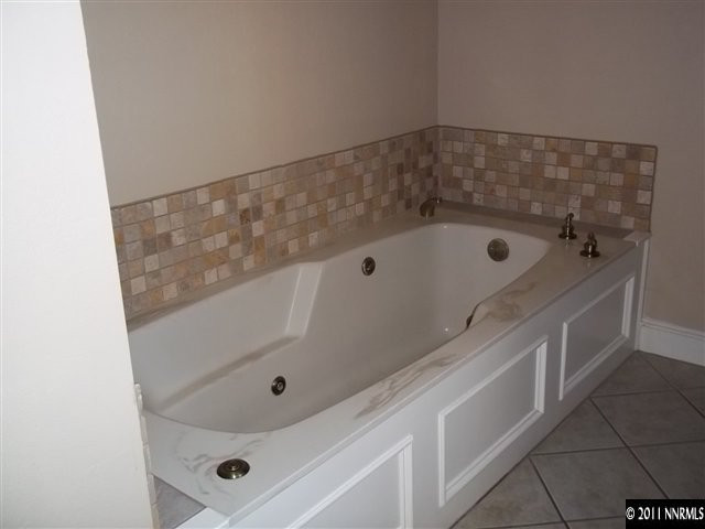 1000 Lampe Road Reno, NV 89511 - Photo 10 of 13 a bathroom with a tub and shower