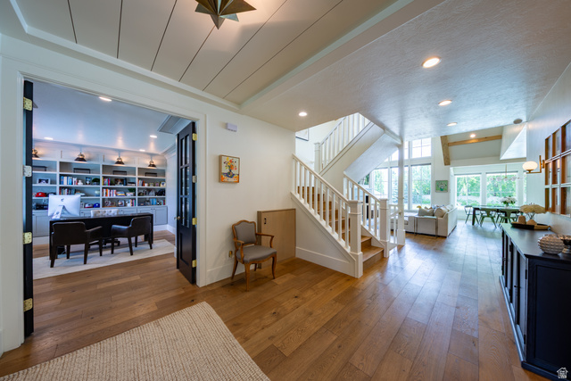 630 East Center Street Alpine, UT 84004 - Photo 12 of 115 Wide plank wood-finish flooring extends through the open concept living areas, featuring a prominent staircase with white balusters