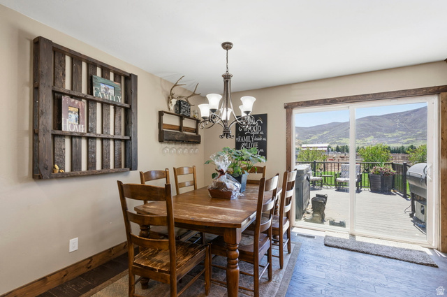781 West 3000 South Heber City, UT 84032 - Photo 10 of 30 Dining area featuring hardwood / wood-style flooring, a chandelier, and a mountain view