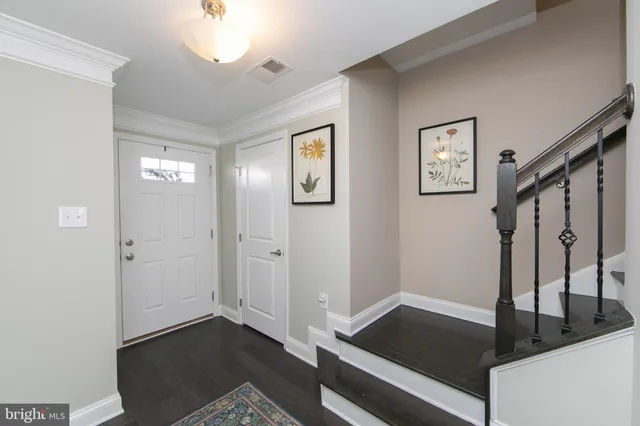 a view of an entryway with wooden floor