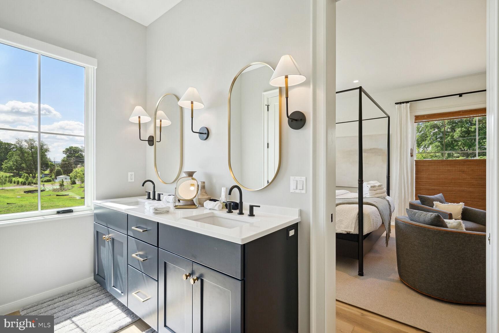 601 Martingale Ridge Drive Middleburg, VA 20117 - Photo 20 of 51 a bathroom with a double vanity sink a mirror and a bathtub