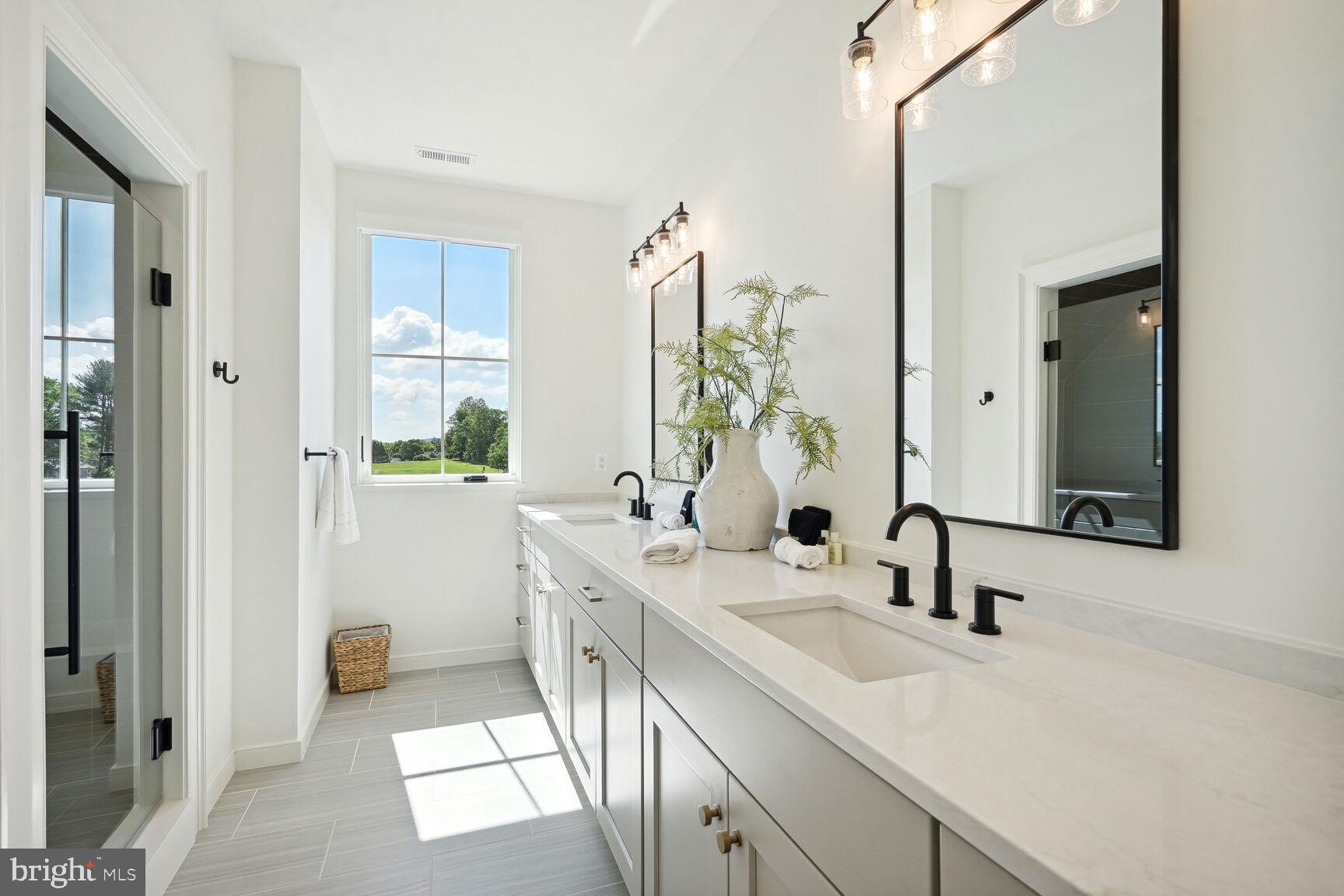 601 Martingale Ridge Drive Middleburg, VA 20117 - Photo 25 of 51 a en suite bathroom with a double vanity sink and a mirror