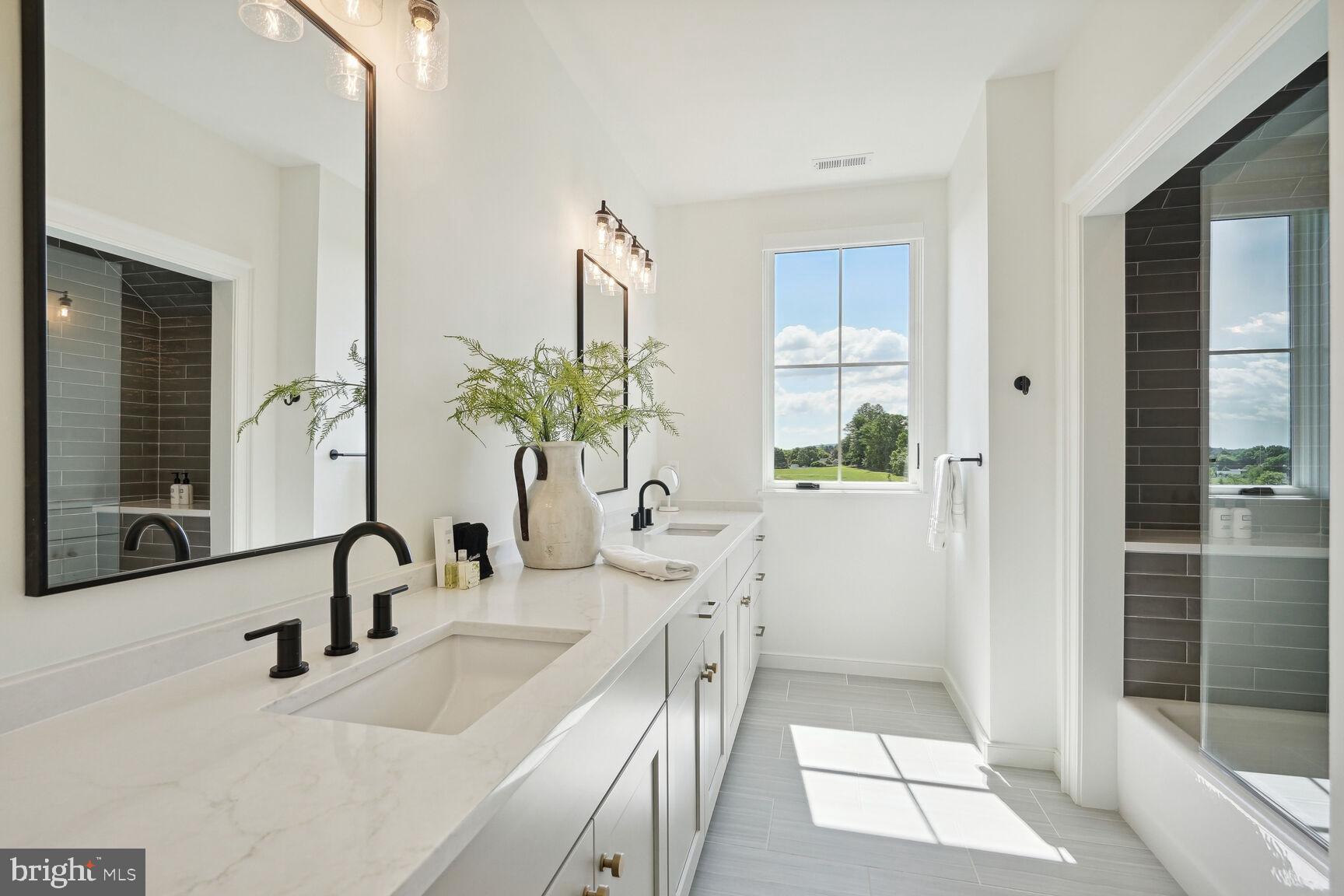 601 Martingale Ridge Drive Middleburg, VA 20117 - Photo 27 of 51 a bathroom with a double vanity sink and a mirror