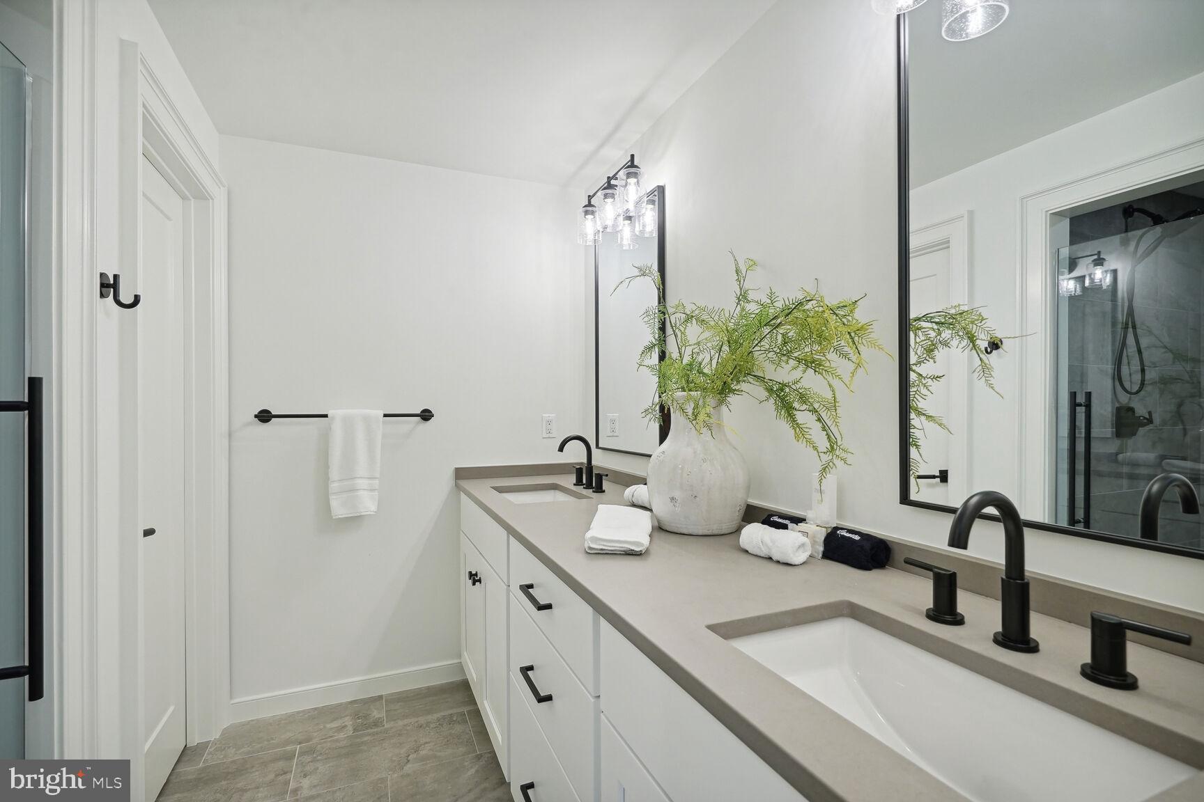 601 Martingale Ridge Drive Middleburg, VA 20117 - Photo 35 of 51 a bathroom with a double vanity sink and a mirror