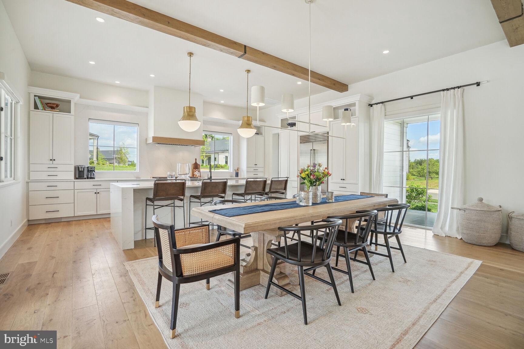 601 Martingale Ridge Drive Middleburg, VA 20117 - Photo 10 of 51 a dining hall with stainless steel appliances a table and chairs with wooden floor