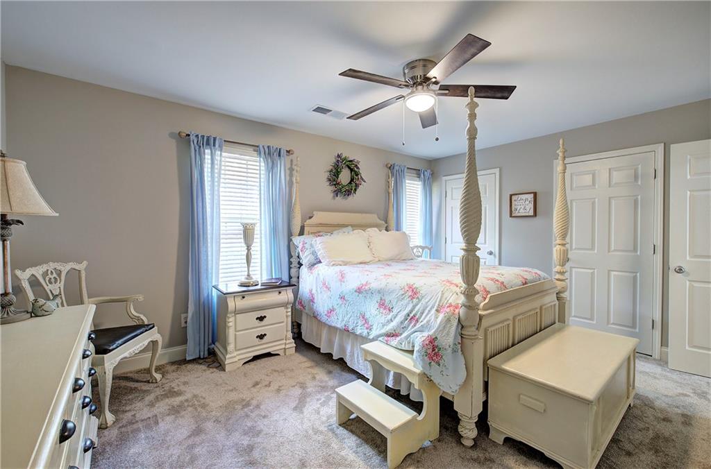 618 Manor Way Cartersville, GA 30120 - Photo 18 of 35 a bedroom with a bed and a chandelier