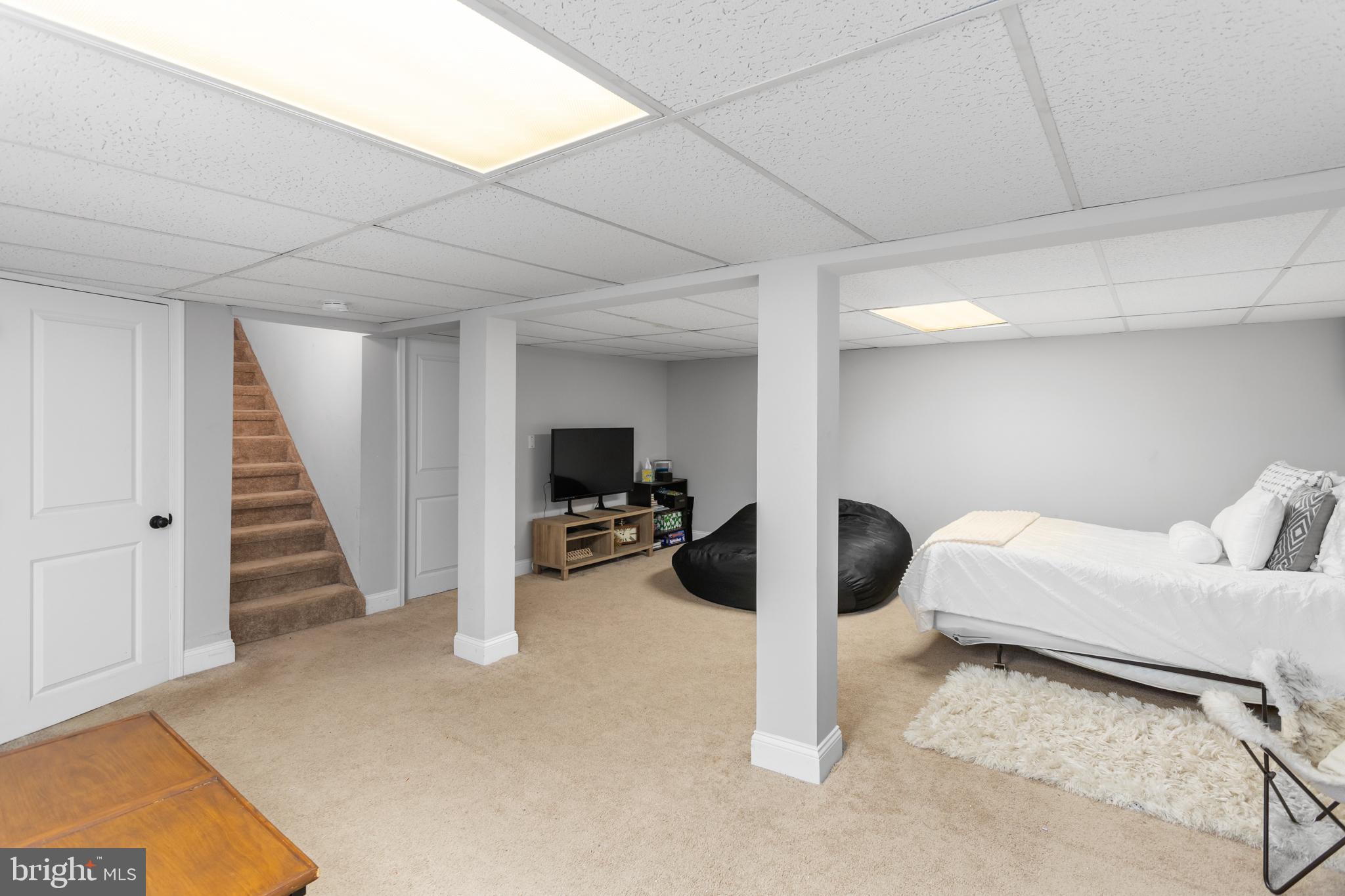 23 Brown Drive Hamilton, NJ 08690 - Photo 23 of 34 a bedroom with furniture and a flat screen tv
