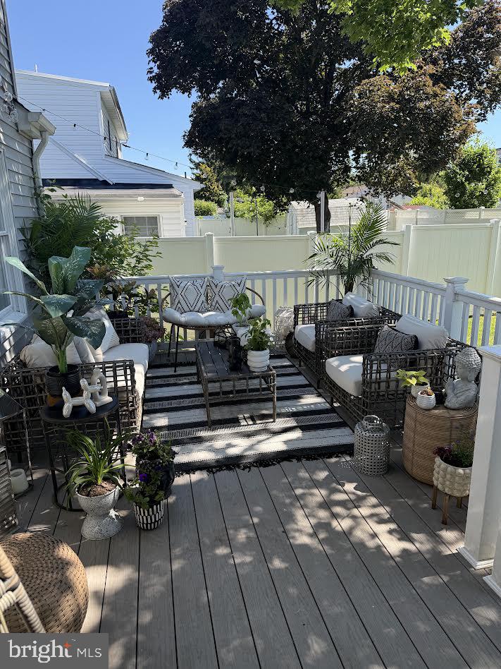23 Brown Drive Hamilton, NJ 08690 - Photo 30 of 34 a view of a patio with couches table and chairs under an umbrella with large trees