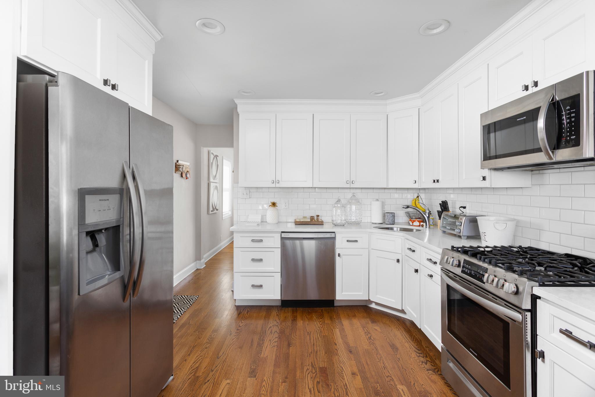 23 Brown Drive Hamilton, NJ 08690 - Photo 8 of 34 a kitchen with stainless steel appliances a stove a sink and a refrigerator