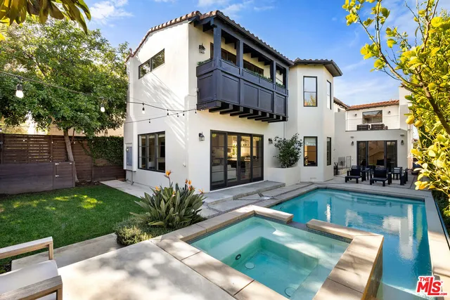 a living room with furniture a fireplace and a floor to ceiling window