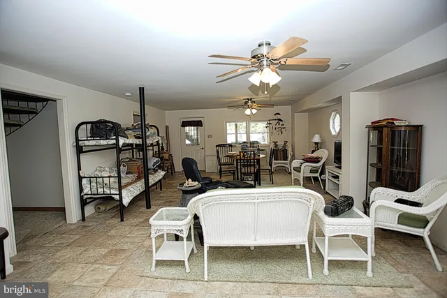 a living room with furniture a flat screen tv and a rug