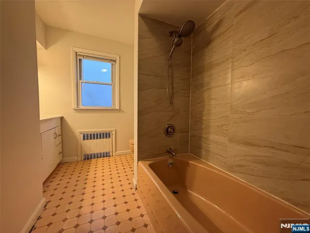 a bathroom with a bathtub and shower