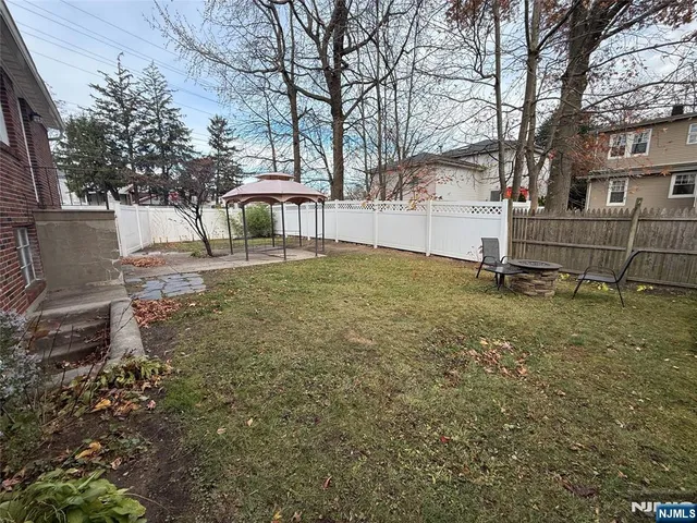 a white house that has a tree in front of it
