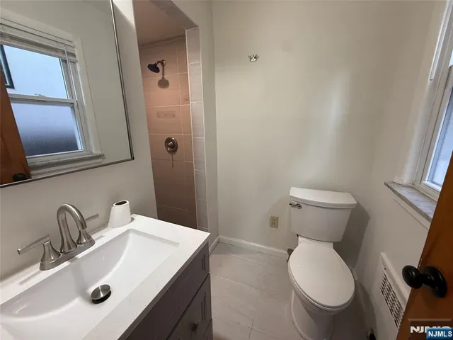 a bathroom with a sink toilet and mirror