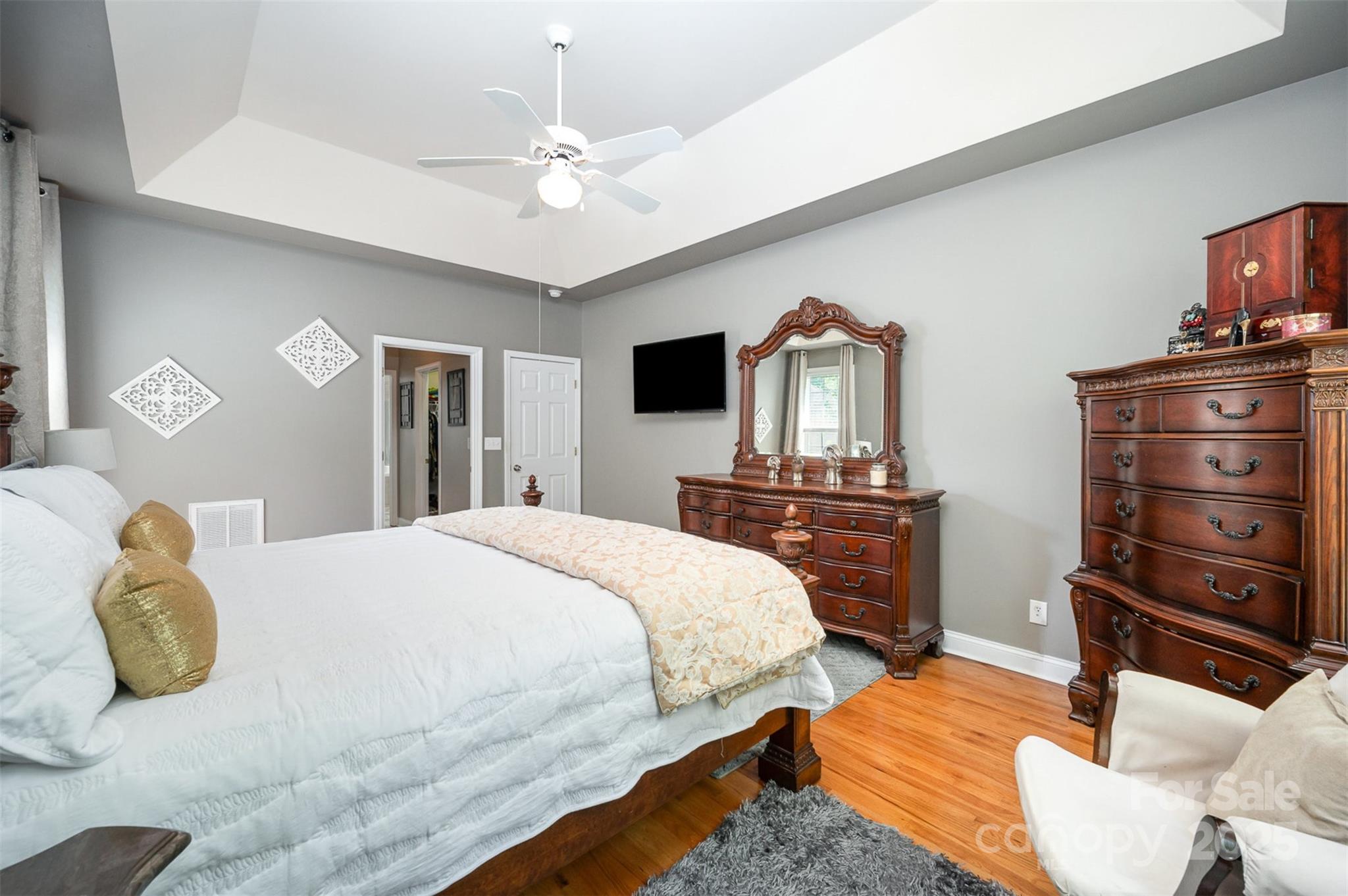 2804 Pulaski Drive Monroe, NC 28110 - Photo 11 of 30 a bedroom with a bed a dresser and flat screen tv