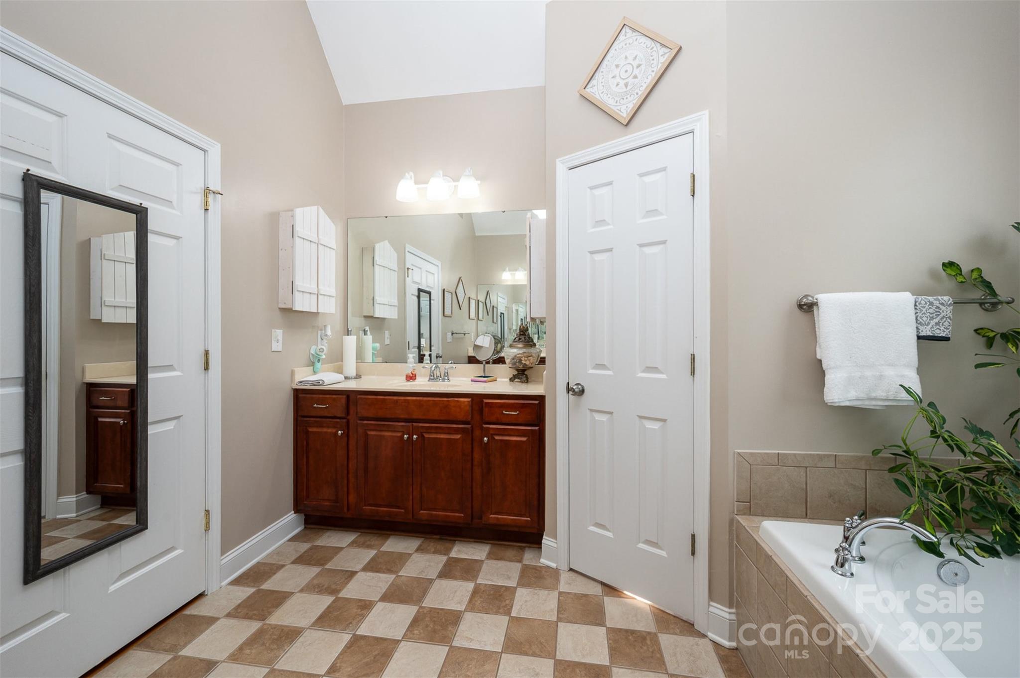 2804 Pulaski Drive Monroe, NC 28110 - Photo 13 of 30 a bathroom with a sink a mirror and a shower