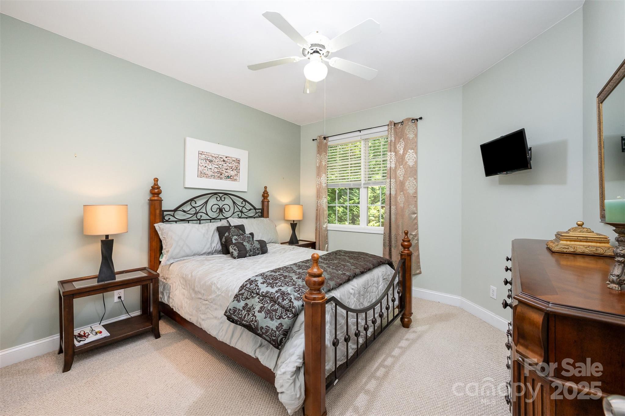 2804 Pulaski Drive Monroe, NC 28110 - Photo 15 of 30 a bedroom with a bed a flat screen tv and a chandelier