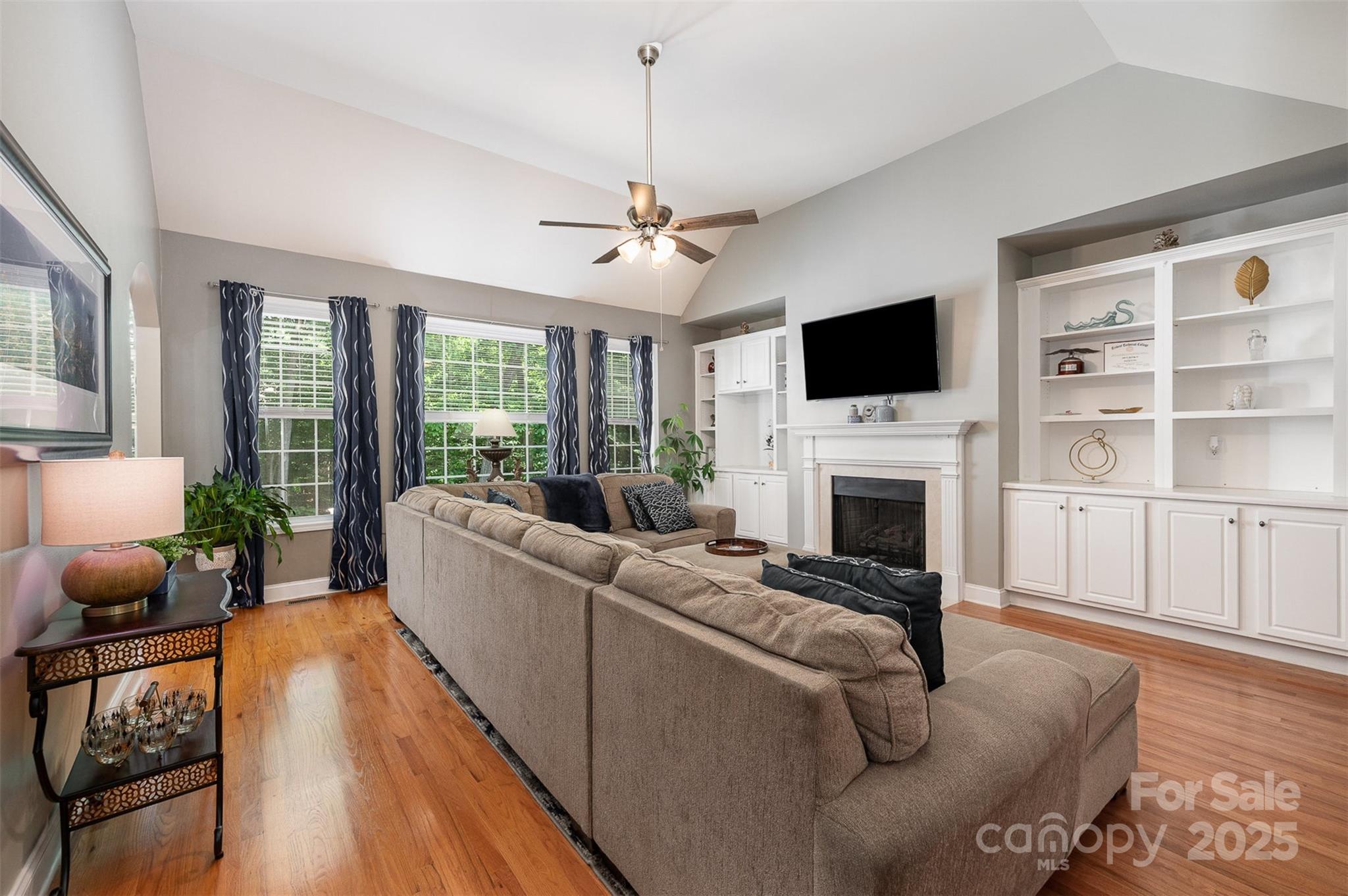2804 Pulaski Drive Monroe, NC 28110 - Photo 4 of 30 a living room with furniture a fireplace and a flat screen tv