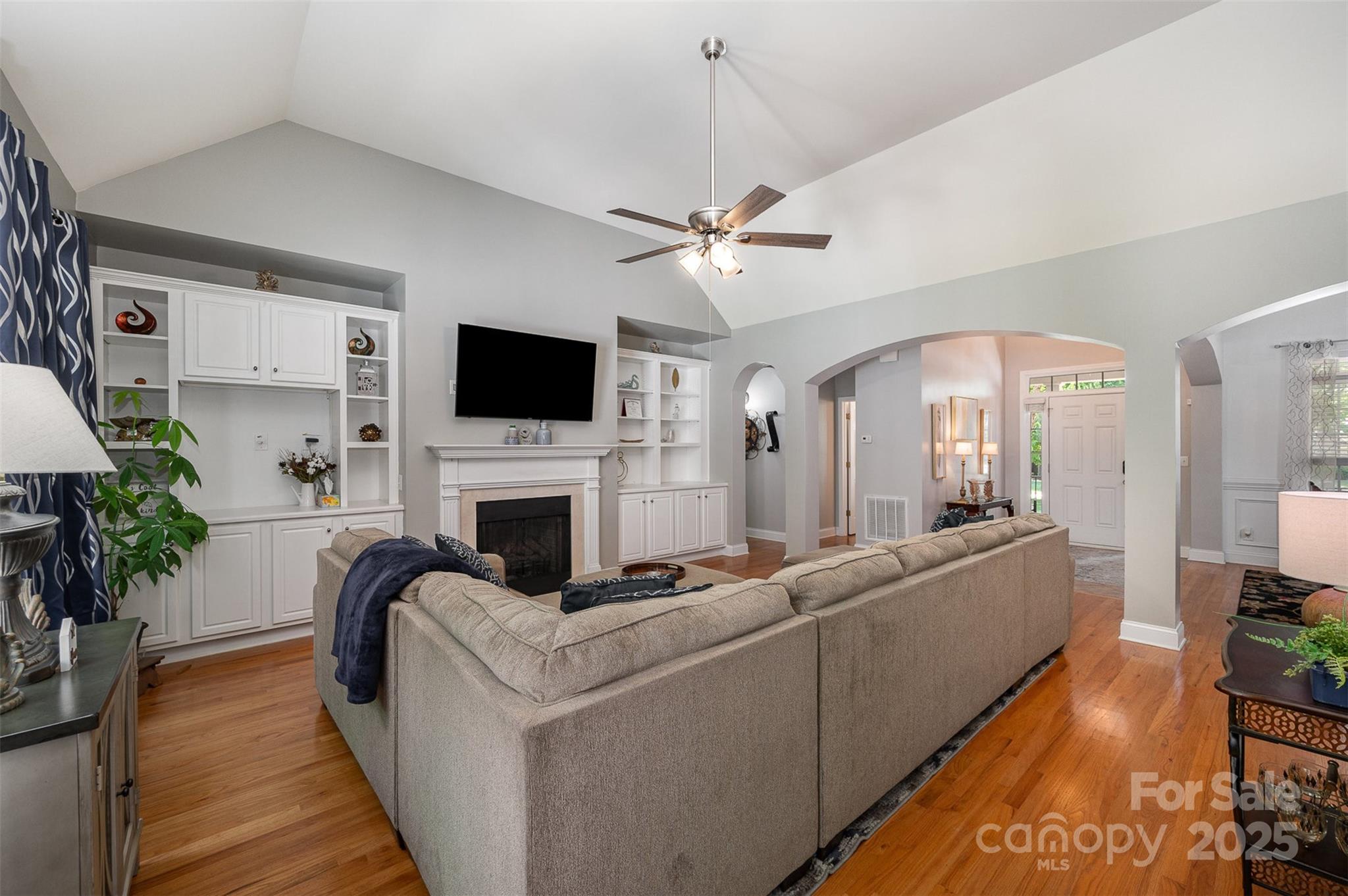 2804 Pulaski Drive Monroe, NC 28110 - Photo 5 of 30 a living room with furniture a fireplace and a flat screen tv