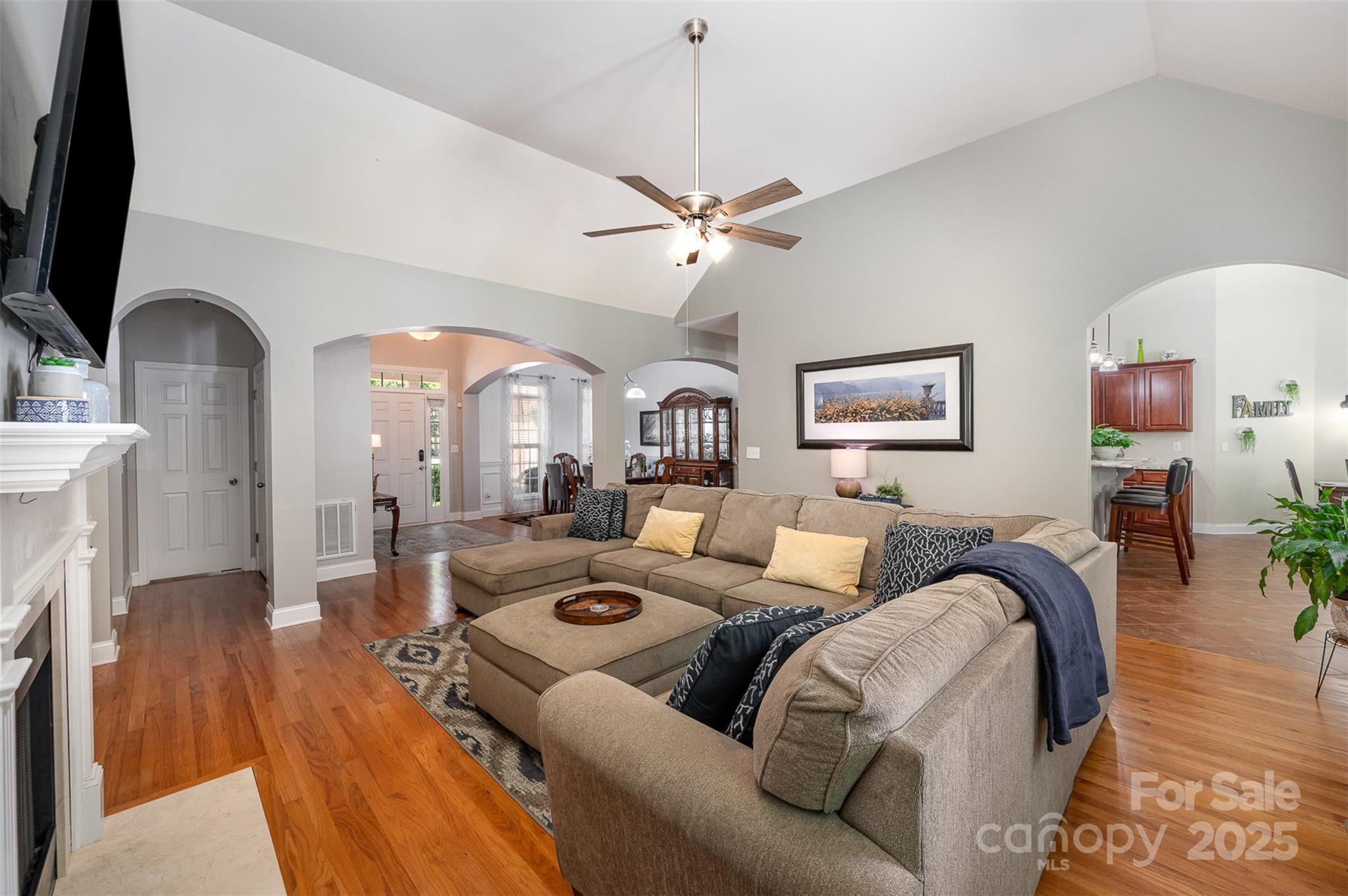 2804 Pulaski Drive Monroe, NC 28110 - Photo 6 of 30 a living room with furniture a fireplace and a flat screen tv