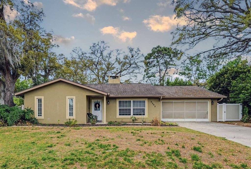 9062 Blackstone Street Spring Hill, FL 34608 - Photo 1 of 49 front view of a house with a yard