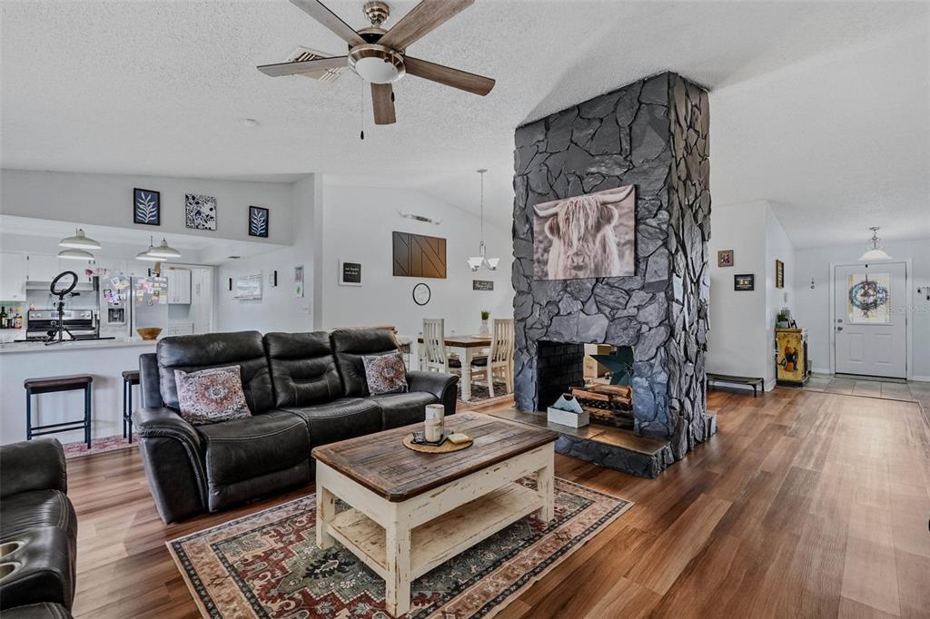 9062 Blackstone Street Spring Hill, FL 34608 - Photo 14 of 49 a living room with furniture and a fireplace