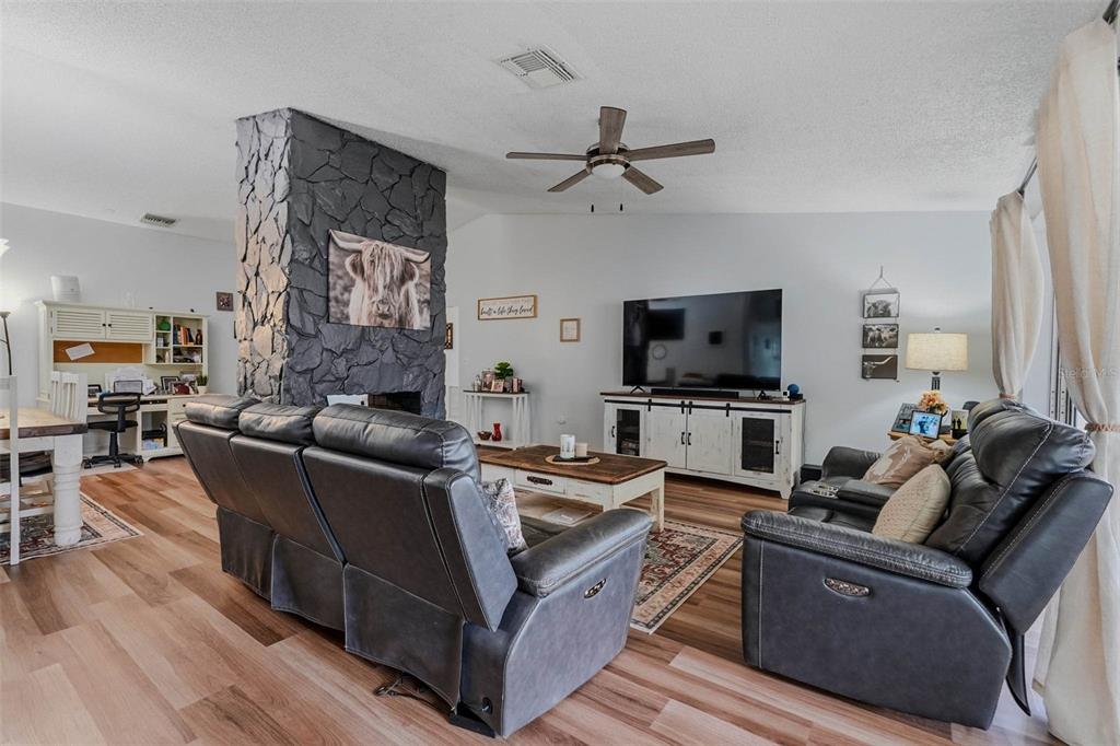 9062 Blackstone Street Spring Hill, FL 34608 - Photo 15 of 49 a living room with furniture and a flat screen tv