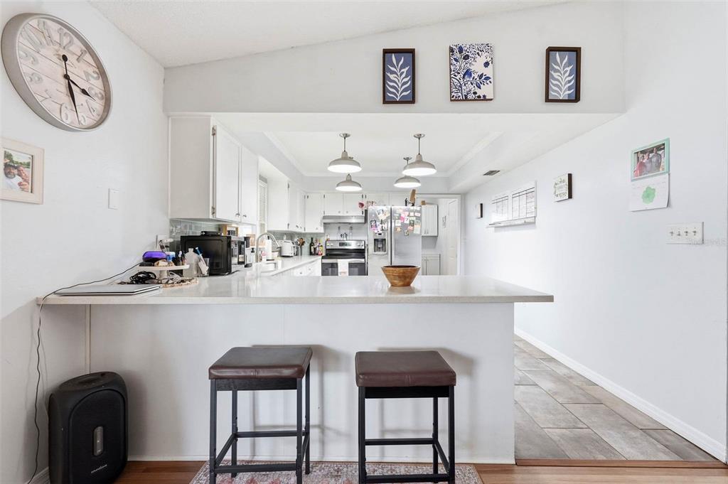 9062 Blackstone Street Spring Hill, FL 34608 - Photo 16 of 49 a kitchen with a refrigerator and a table