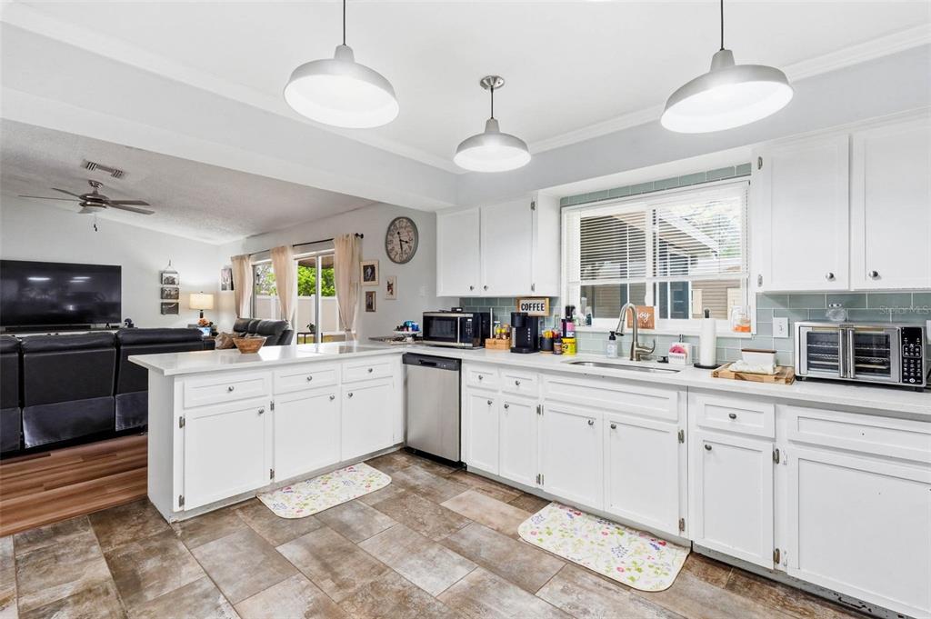 9062 Blackstone Street Spring Hill, FL 34608 - Photo 18 of 49 a kitchen with white cabinets and sink