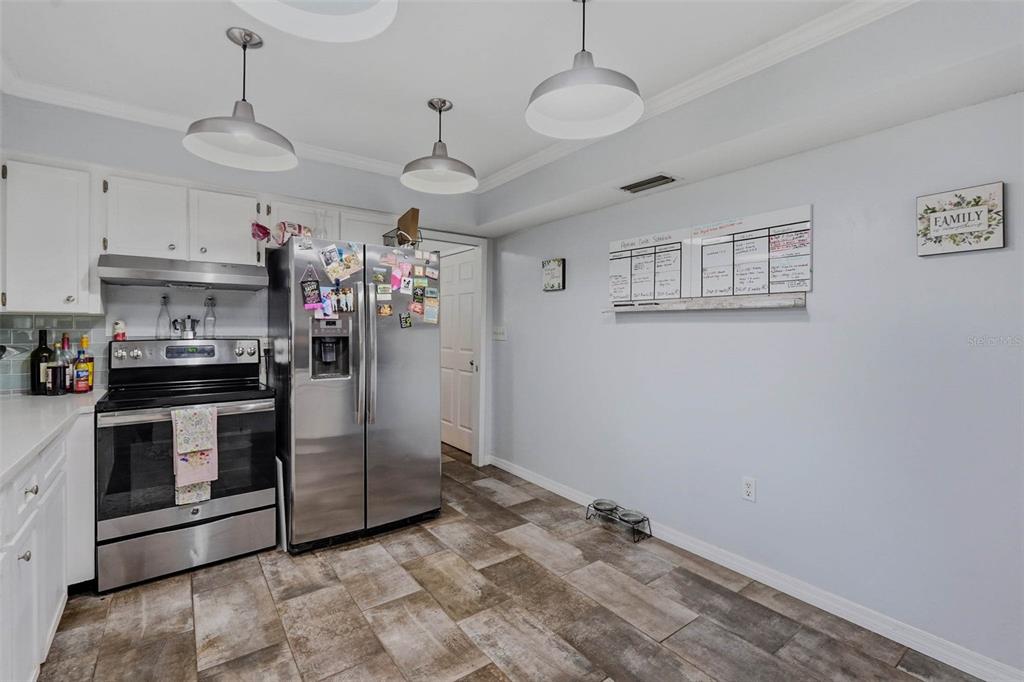 9062 Blackstone Street Spring Hill, FL 34608 - Photo 20 of 49 a view of a kitchen with stainless steel appliances granite countertop a stove a refrigerator and a sink