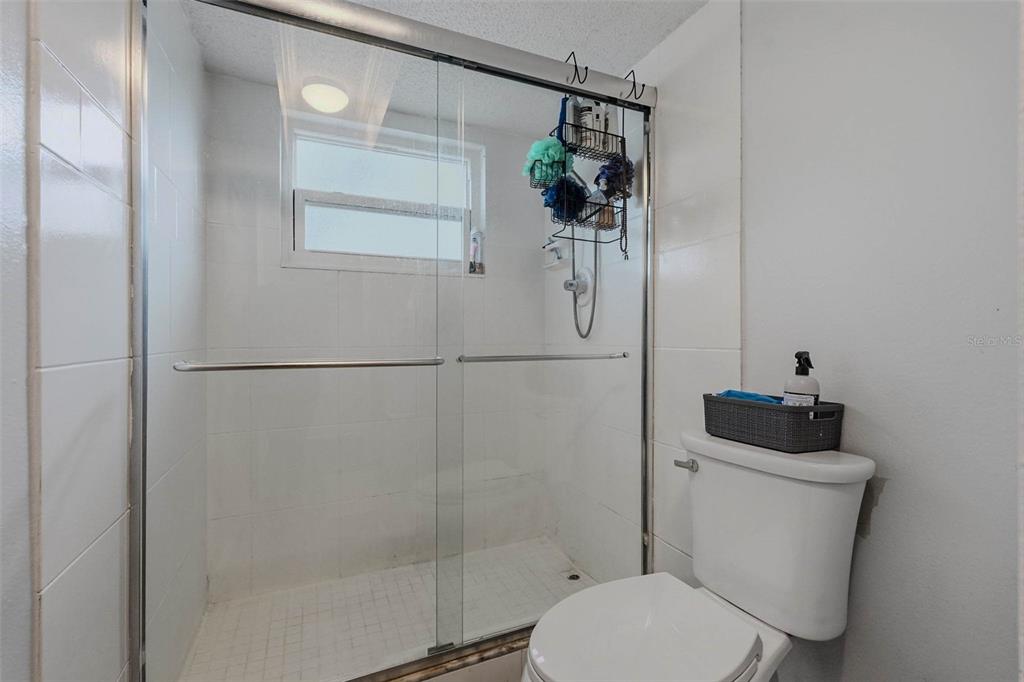 9062 Blackstone Street Spring Hill, FL 34608 - Photo 24 of 49 a bathroom with a toilet and a shower