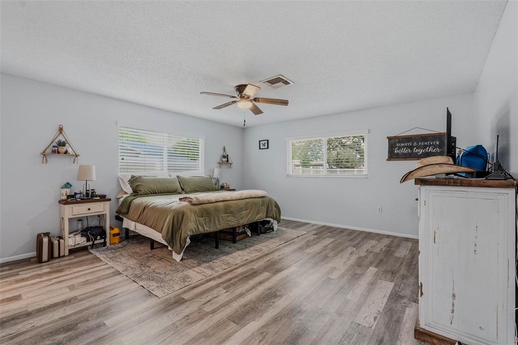 9062 Blackstone Street Spring Hill, FL 34608 - Photo 25 of 49 a bedroom with a bed and a chandelier