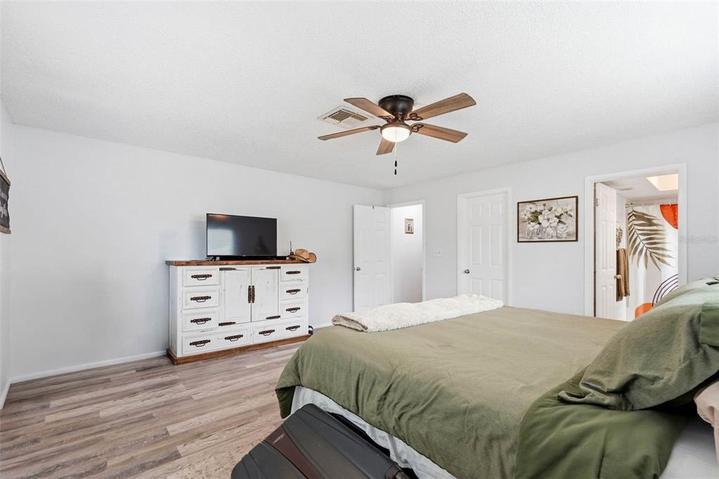 9062 Blackstone Street Spring Hill, FL 34608 - Photo 26 of 49 a bedroom with a bed and a flat screen tv