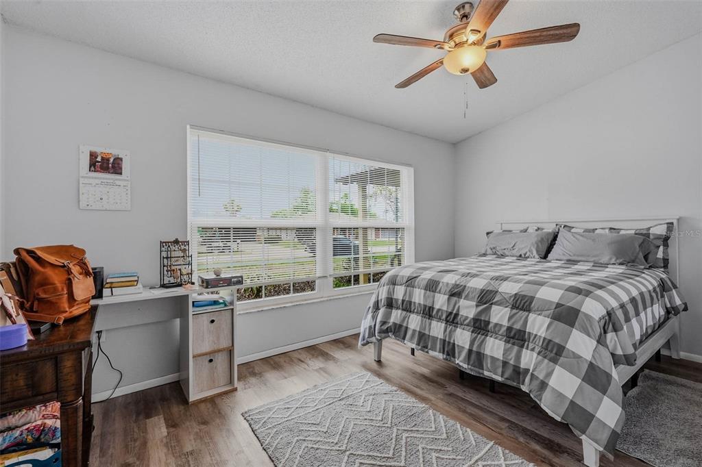 9062 Blackstone Street Spring Hill, FL 34608 - Photo 29 of 49 a bedroom with a bed and a desk