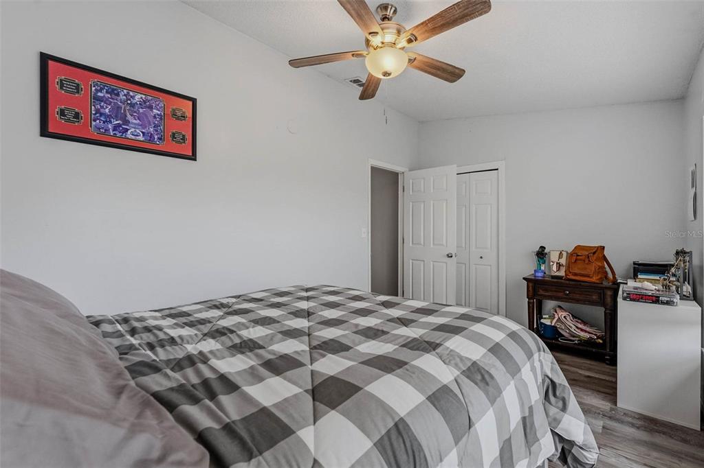 9062 Blackstone Street Spring Hill, FL 34608 - Photo 30 of 49 a bedroom with a bed and a chandelier