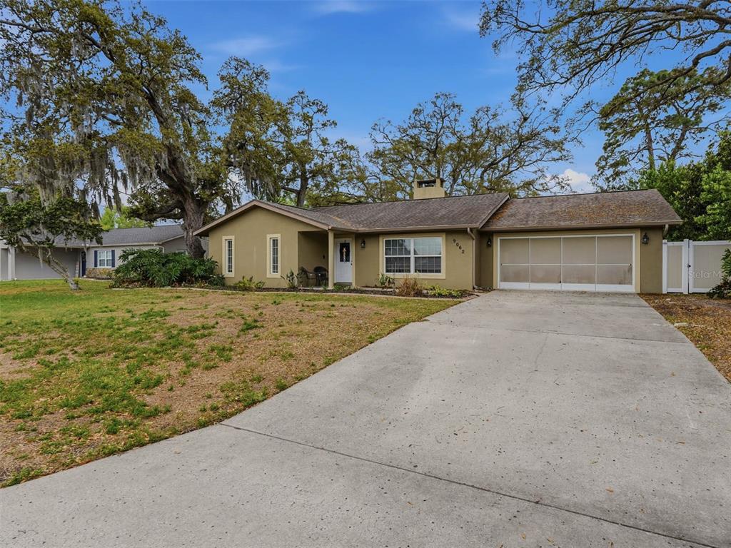 9062 Blackstone Street Spring Hill, FL 34608 - Photo 3 of 49 a house with trees in the background