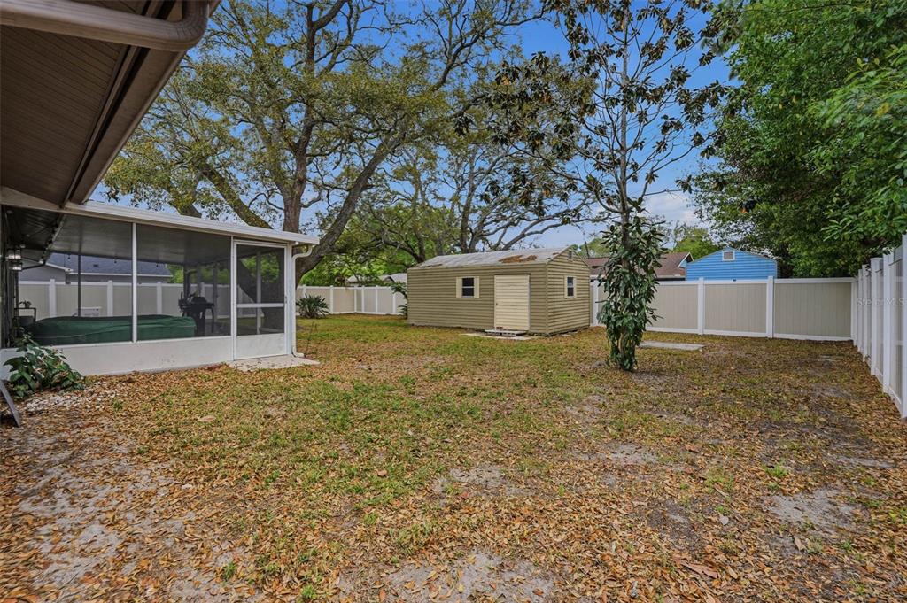 9062 Blackstone Street Spring Hill, FL 34608 - Photo 35 of 49 a house with trees in front of it