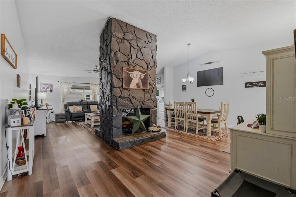 9062 Blackstone Street Spring Hill, FL 34608 - Photo 8 of 49 a living room with furniture a wooden floor and a flat screen tv