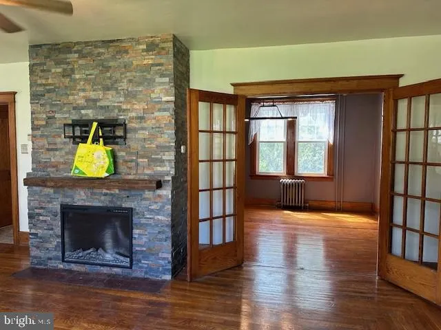 a living room with a fireplace and a wooden floor