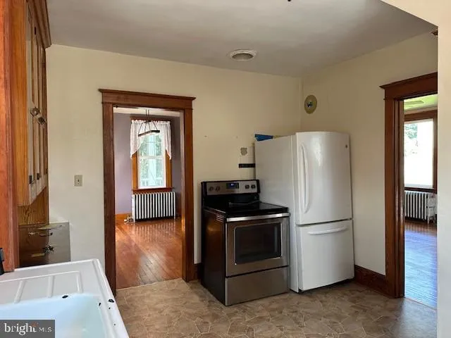 a kitchen with stainless steel appliances a refrigerator and a stove