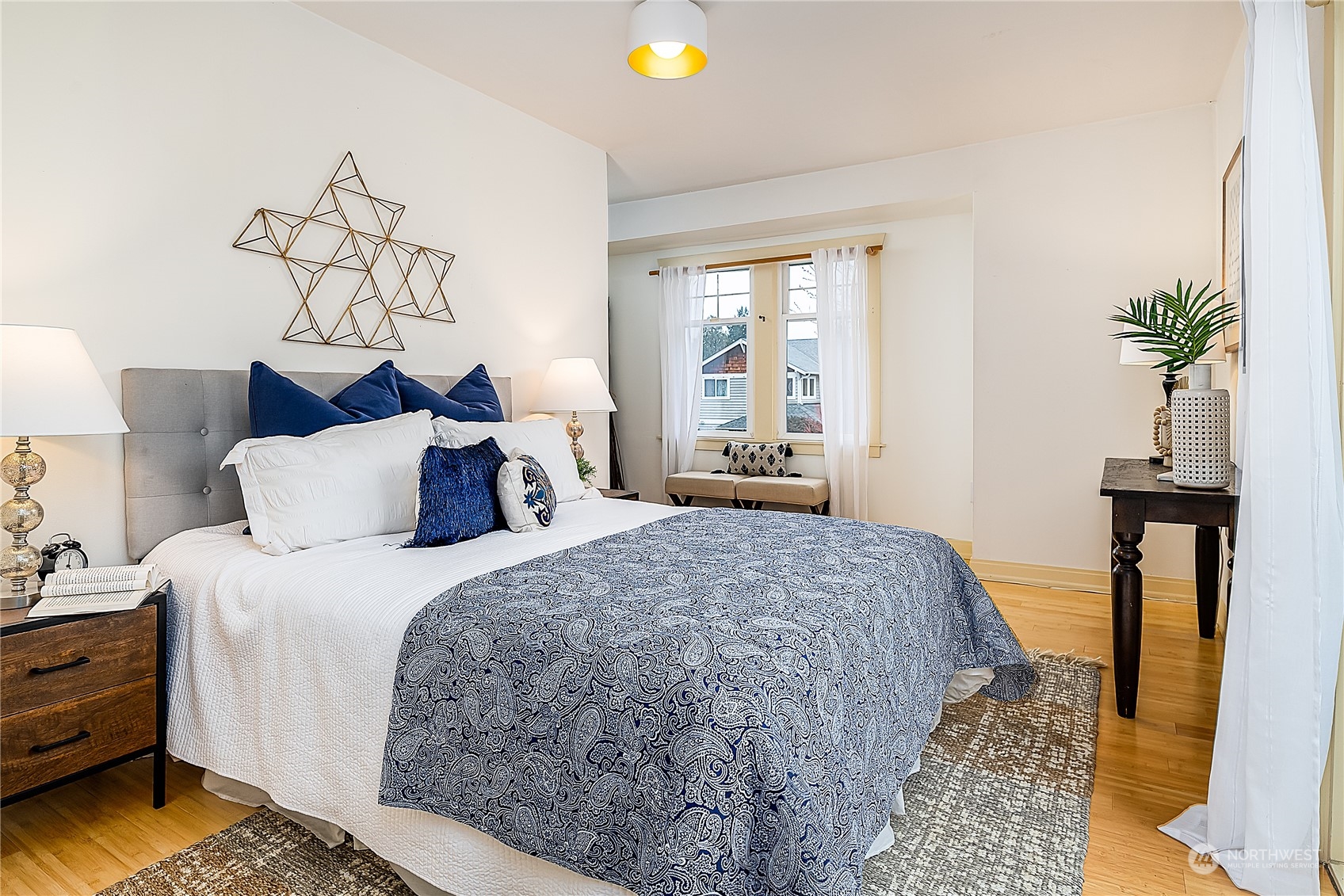 4100 Southwest Raymond Street Seattle, WA 98136 - Photo 11 of 23 a bedroom with bed and wooden floor