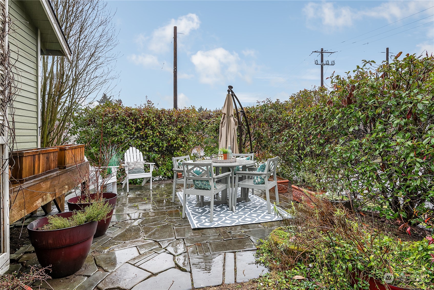 4100 Southwest Raymond Street Seattle, WA 98136 - Photo 3 of 23 a view of a patio with table and chairs potted plants and large tree